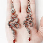 ER-Hand Holding Snake red gem